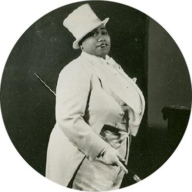 Cropped black and white portrait of Gladys Bentley wearing a white tuxedo and top hat
