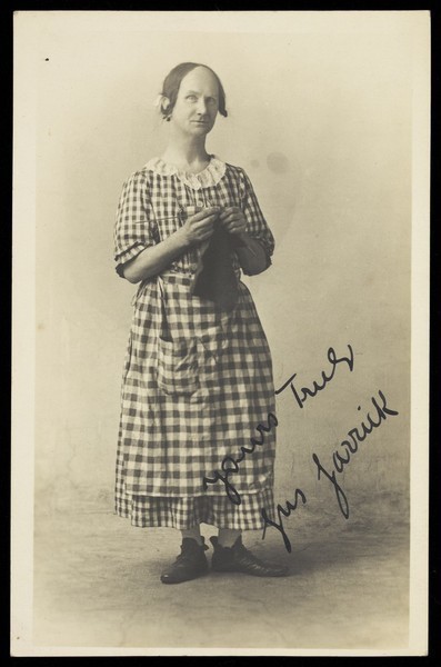 Download the full-sized image of Gus Garrick in drag as a pantomime dame. Photographic postcard, 191-.