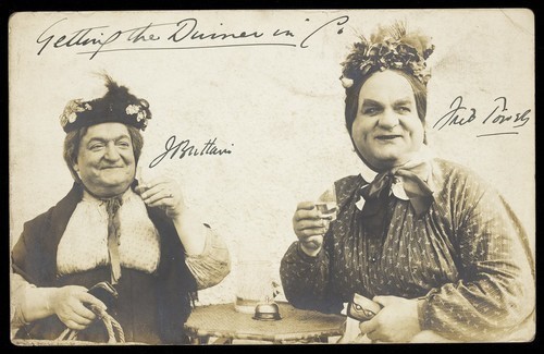 Download the full-sized image of Two actors, both in drag, pose in character as old women. Photographic postcard, 191-.