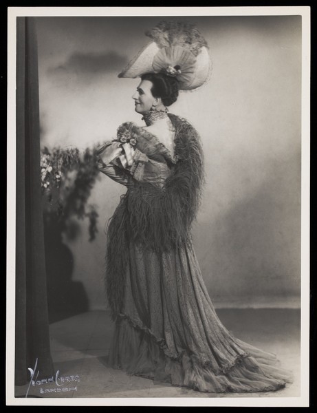 Download the full-sized image of An actor in drag, performing on stage. Photograph by Mme Yvonne, 194-.