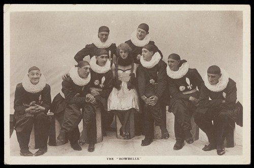 Download the full-sized image of Soldiers, one in drag, performing in a concert party as "The Bow Bells"; posing for a group portrait. Photographic postcard, 191-.