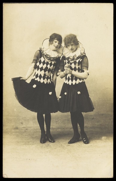 Download the full-sized image of Two actors in drag, performing in character; wearing matching costume. Photograph, 191-.