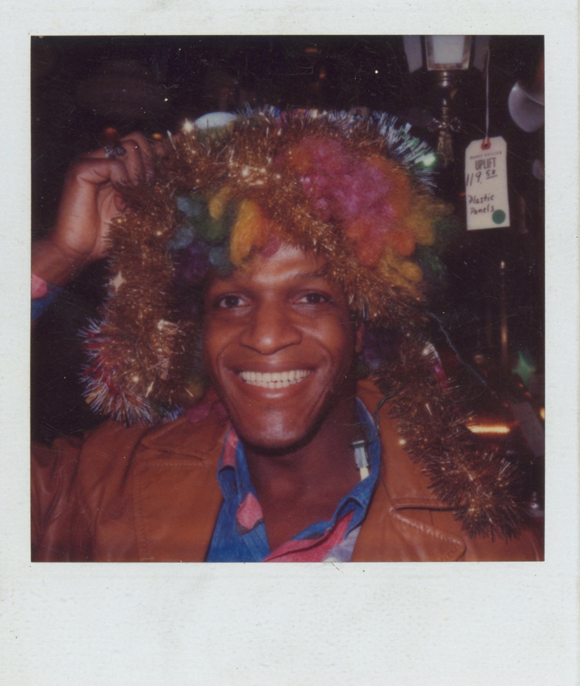 Download the full-sized image of A Photograph of Marsha P. Johnson with a Rainbow Wig and Tinsel on Her Head