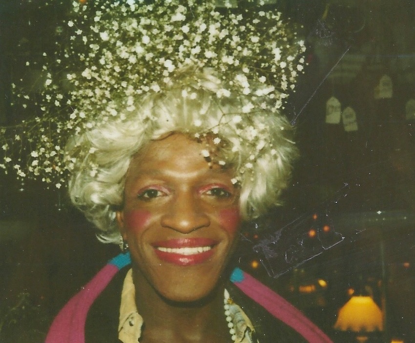 Download the full-sized image of A Photograph of Marsha P. Johnson Smiling and Wearing a Baby's Breath Flower Headpiece