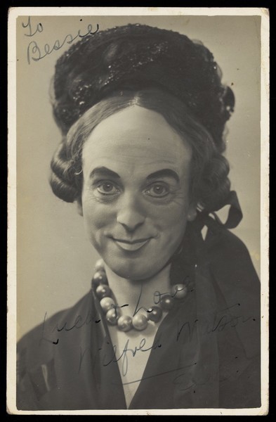 Download the full-sized image of Wilfred Watson in drag. Photographic postcard.