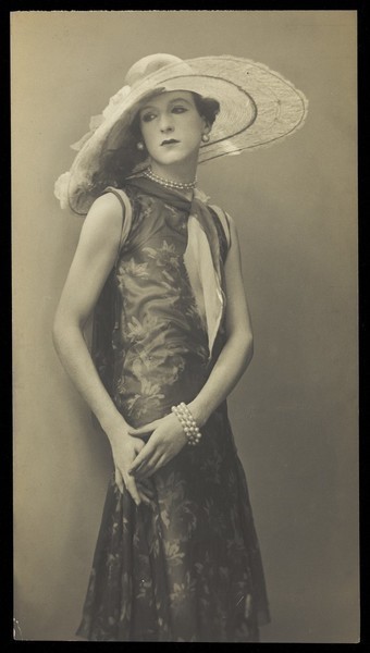 Download the full-sized image of Cecil Beaton, in drag; dressed in a patterned dress. Photograph, ca. 1925.