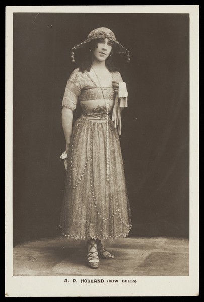 Download the full-sized image of A.P. Holland in drag posing for the Bow Bells concert party. Photographic postcard, 191-.
