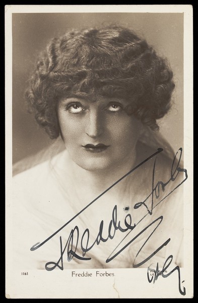 Download the full-sized image of Freddie Forbes in drag impersonating Clara Bow. Photographic postcard by Fielding, 1929.