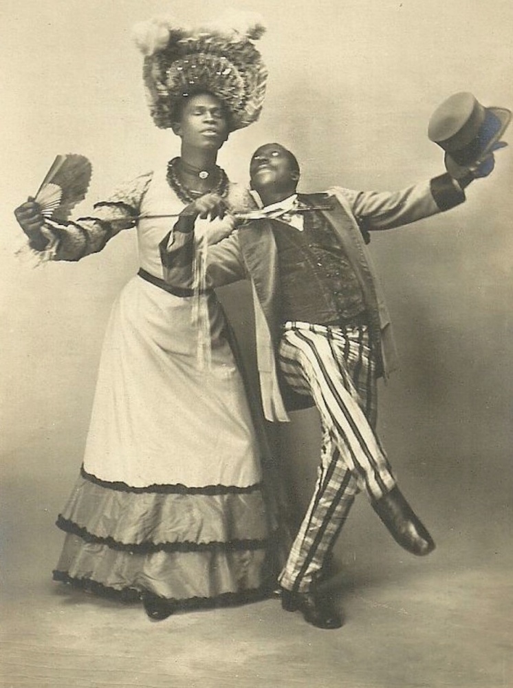 Download the full-sized image of Jack Brown Poses in Drag alongside Dance Partner Charles Gregory with Arm Outstretched