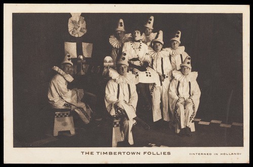 Download the full-sized image of British prisoners of war, one in drag, posing for "The Timbertown Follies", at a prisoner of war camp in Groningen. Process print, 191-.