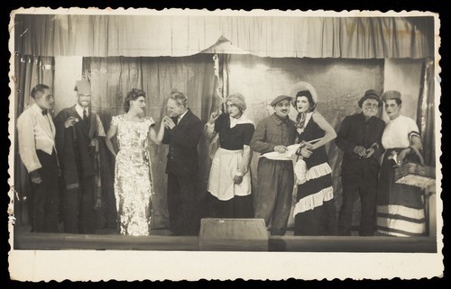 Download the full-sized image of Actors, some in drag, pose at a "French" concert party. Photographic postcard, 1942.