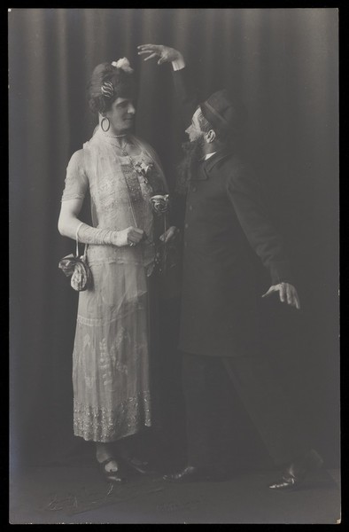 Download the full-sized image of Ralph Mellor in drag and another actor perform a scene in Trilby. Photographic postcard by L.S. Langfier, 192-.