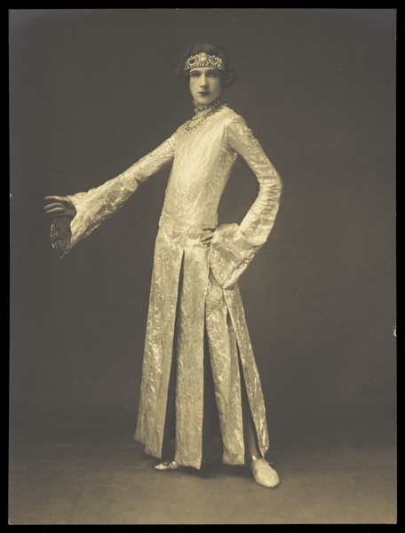 Download the full-sized image of Cecil Beaton, in drag; dressed in a tight-fitting lamé dress. Photograph, ca. 1925.