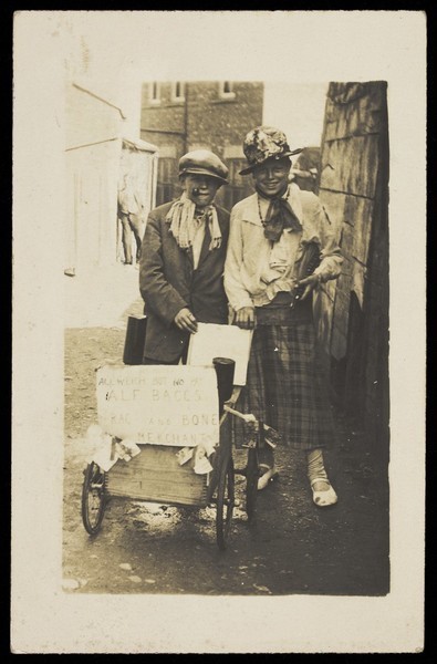 Download the full-sized image of Two young men, one in drag, playing rag and bone men. Photographic postcard, 192-.