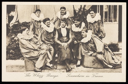 Download the full-sized image of British soldiers in a concert party, one in drag, pose as "The Whizz Bangs". Postcard, 191-.