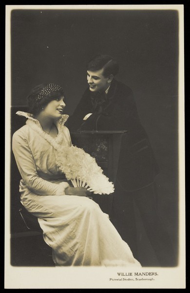 Download the full-sized image of Willie Manders in drag and in men's attire. Photographic postcard, 1914.