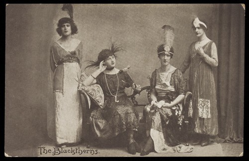 Download the full-sized image of Amateur actors in drag, pose on stage as "The Blackthorns". Photographic postcard, 191-.