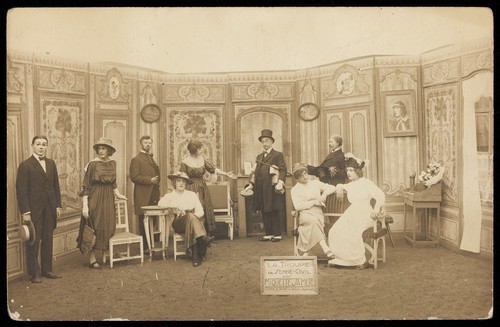 Download the full-sized image of Prisoners of war, some in drag, posing on stage in 'Miquette et sa mere' at Sennelager prisoner of war camp in Germany. Photographic postcard, 191-.