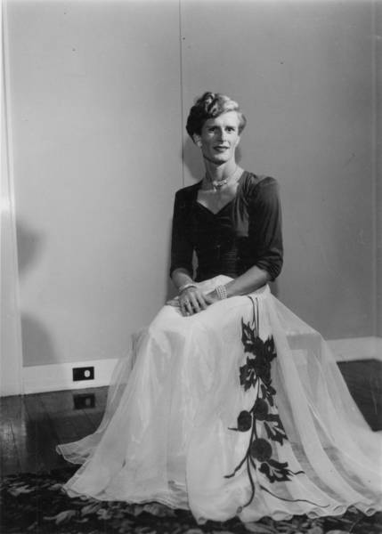 Download the full-sized image of Person Posing on a Chair in a White Skirt and Black Top