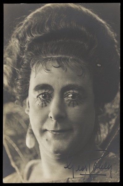 Download the full-sized image of George Robey poses in character, with sunbeam eye make-up. Photographic postcard, 191-.
