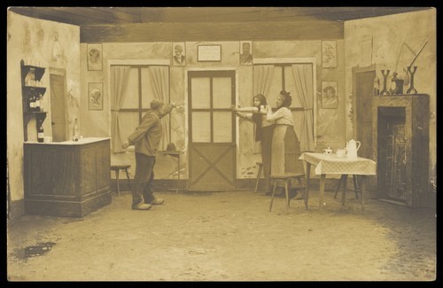 Download the full-sized image of Three actors performing at a prisoner of war camp in Münster. Photographic postcard, ca. 1916.