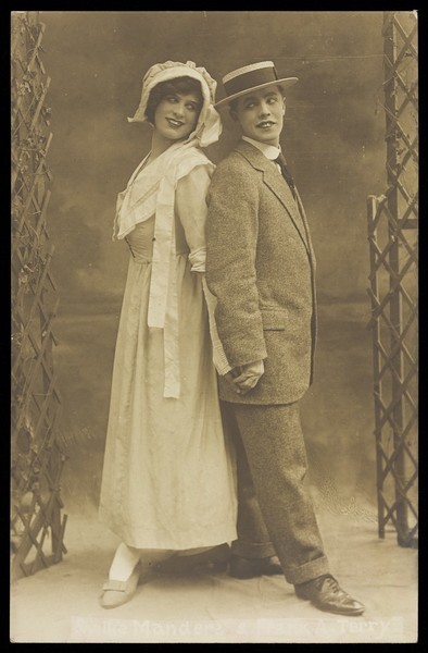 Download the full-sized image of Willie Manders and Frank A. Terry, in character; posing back to back. Photographic postcard, 192-.