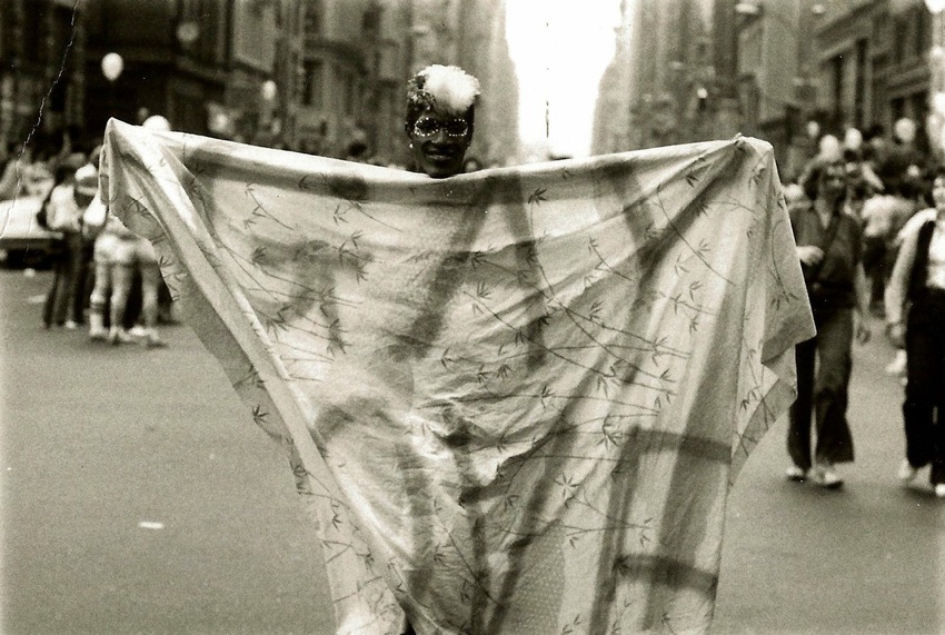Download the full-sized image of A Photograph of Marsha P. Johnson Holding Up a Blanket That Reads “Gay Love”