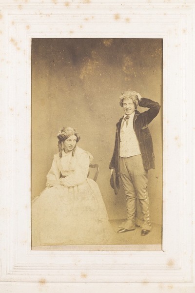 Download the full-sized image of Two men, one in drag, posing with comic expressions. Photograph, 189-.