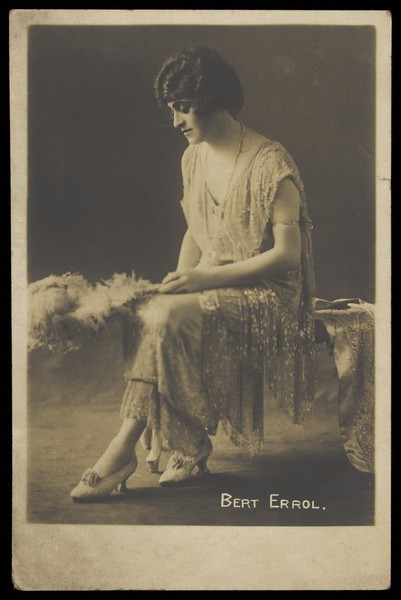 Download the full-sized image of Bert Errol in drag, wearing a light dress. Photographic postcard, 191-.