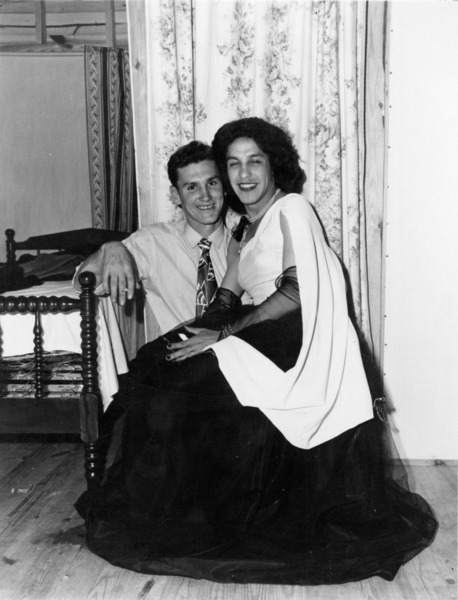 Download the full-sized image of Person in a Black and White Gown Sits on Another Person's Lap