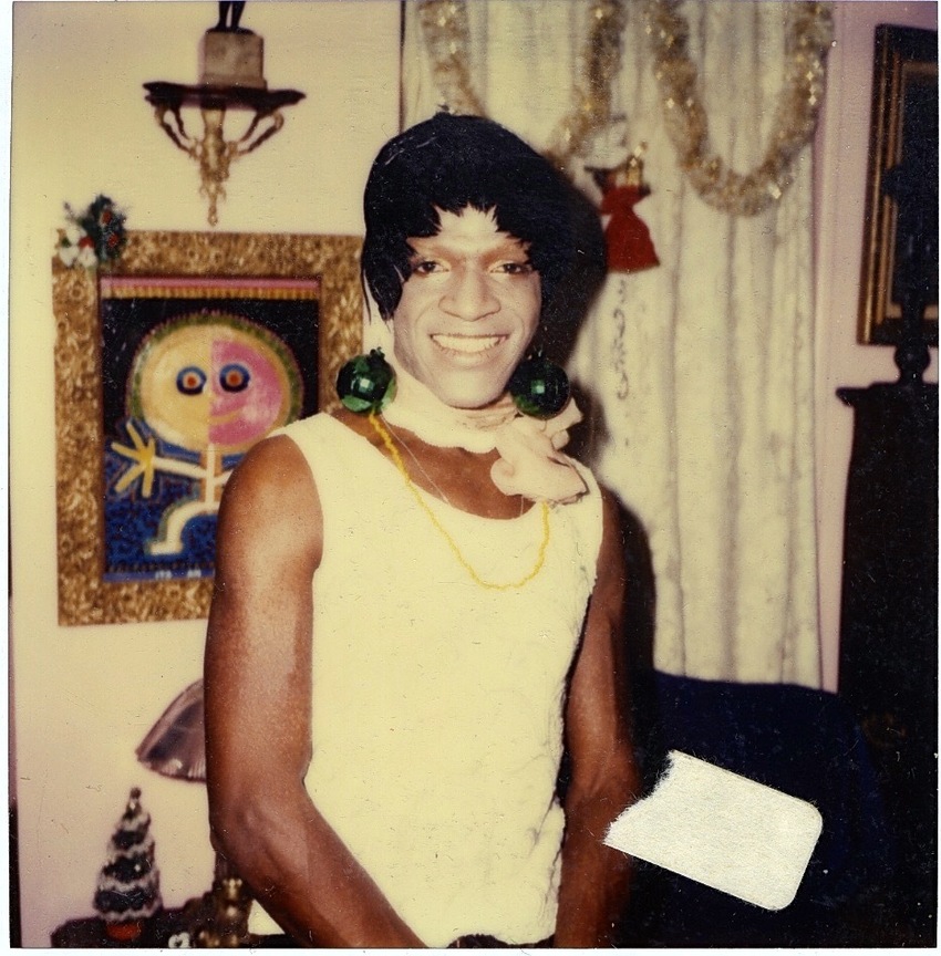 Download the full-sized image of A Photograph of Marsha P. Johnson with a Painted White Face and Green Disco Ball Earrings