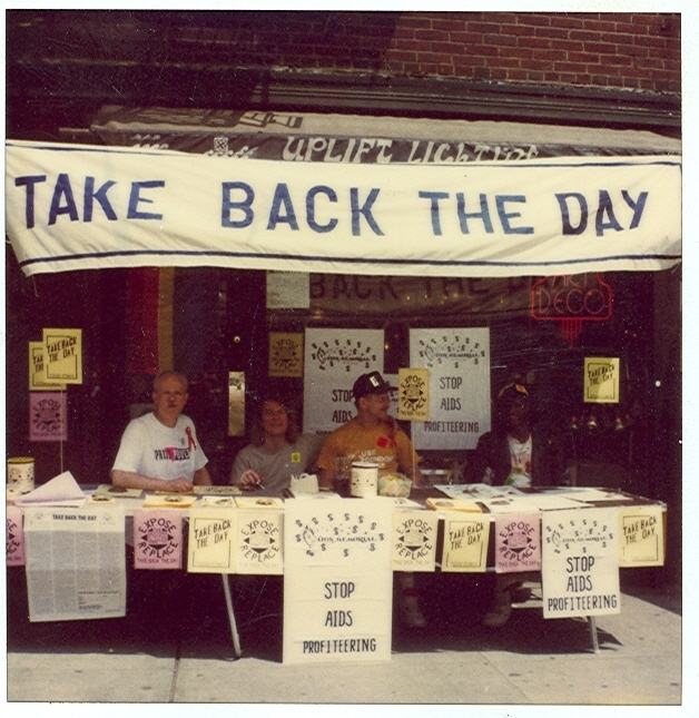 Download the full-sized image of A Photograph of Marsha P. Johnson and Randy Wicker In Front of Uplift Lighting Under a Take Back the Day Banner
