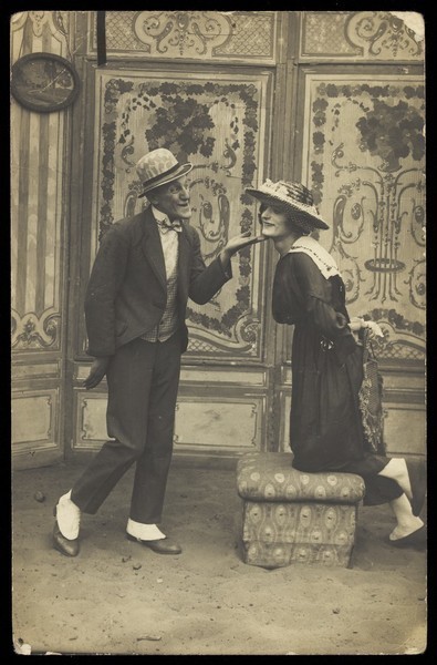 Download the full-sized image of French prisoners of war, one in drag, performing a show at Sennelager prisoner of war camp in Germany. Photographic postcard, 1918.