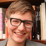 Color photo of Amber Billey in front of bookcase